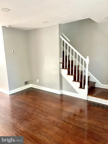 a view of an entryway with wooden floor