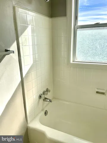 a bath tub sitting next to a window