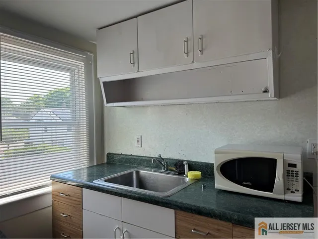 a kitchen with a sink and a microwave