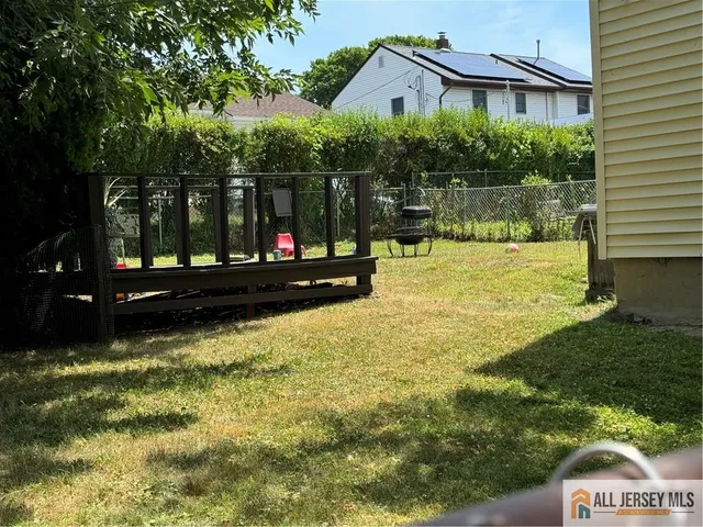 a backyard of a house with lots of green space and fountain