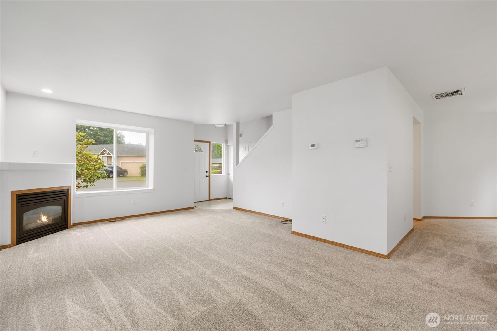 3560 Courtyard Lane Bremerton, WA 98310 - Photo 4 of 26 an empty room with windows and fireplace
