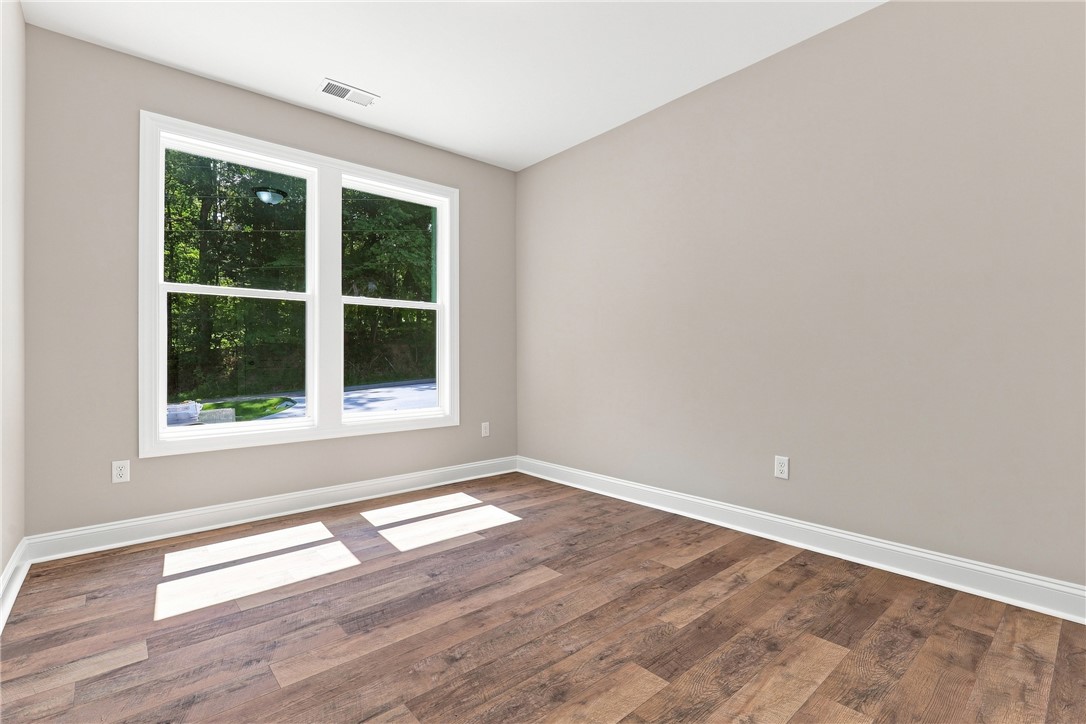 216 West Halfway Branch Road Walhalla, SC 29691 - Photo 17 of 41 Rich wood-look flooring and a large window framing leafy views define this versatile space.