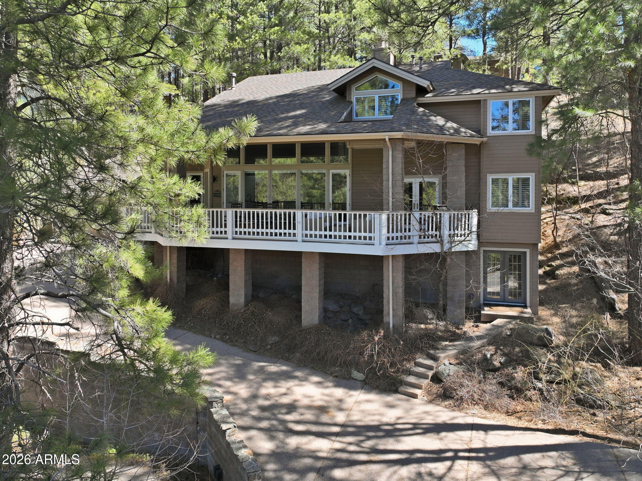 a front view of a house with a yard garage and outdoor seating