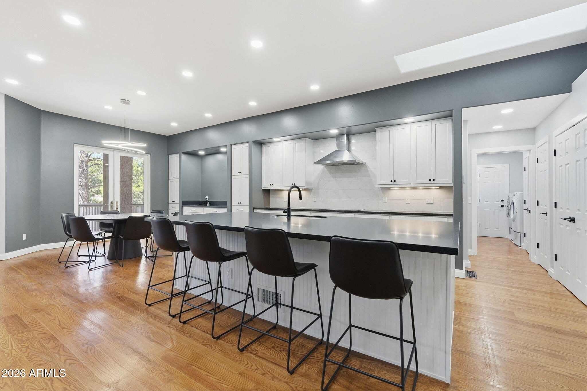 3441 Griffiths Spring Flagstaff, AZ 86005 - Photo 26 of 71 a kitchen with stainless steel appliances kitchen island granite countertop a table and chairs in it