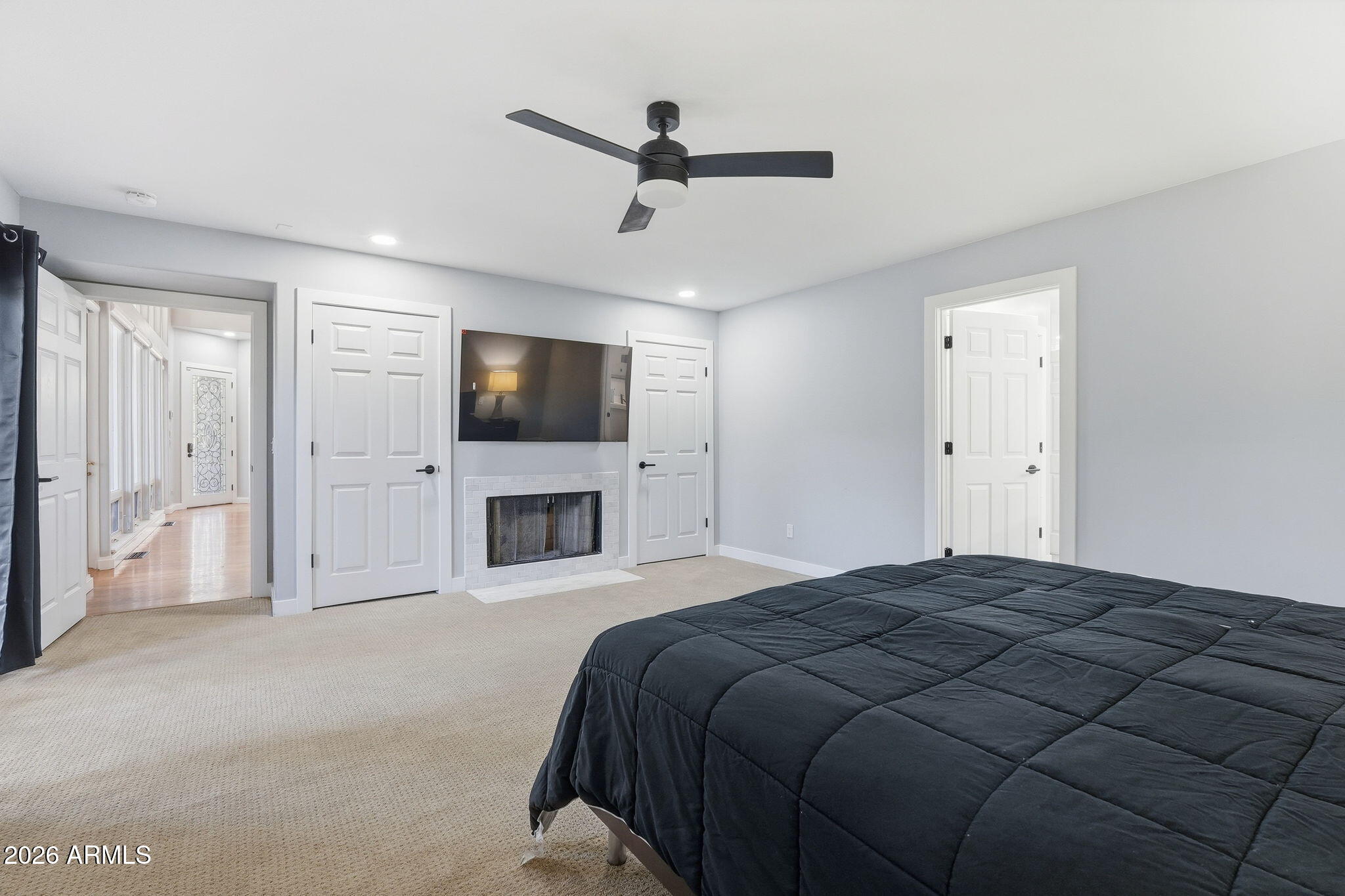 3441 Griffiths Spring Flagstaff, AZ 86005 - Photo 30 of 71 a spacious bedroom with a bed and a flat screen tv