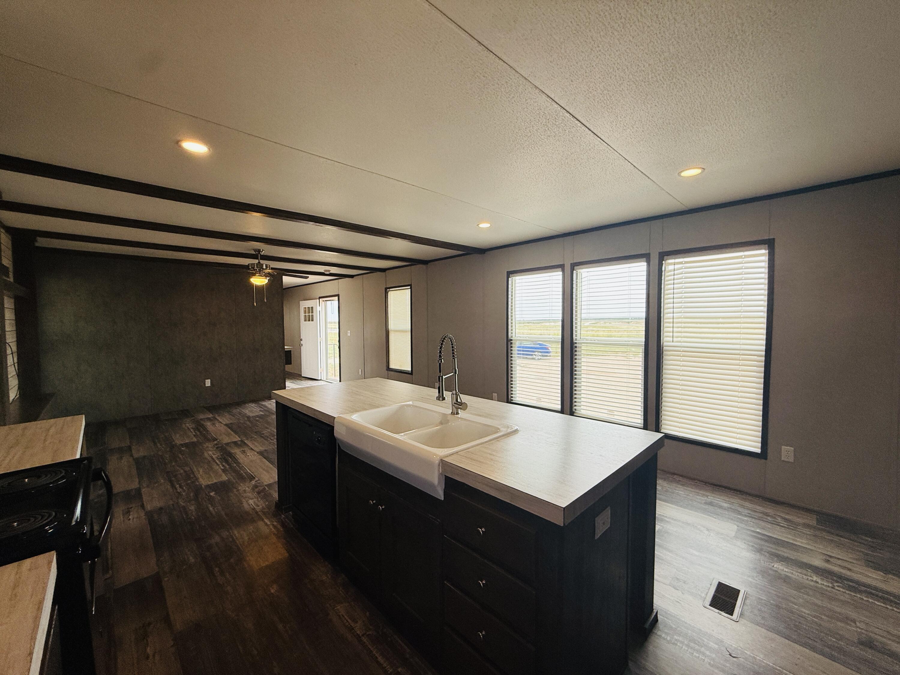 365 Private Road 211 Road North Seminole, TX 79360 - Photo 12 of 22 a spacious bathroom with a double vanity sink and a large mirror