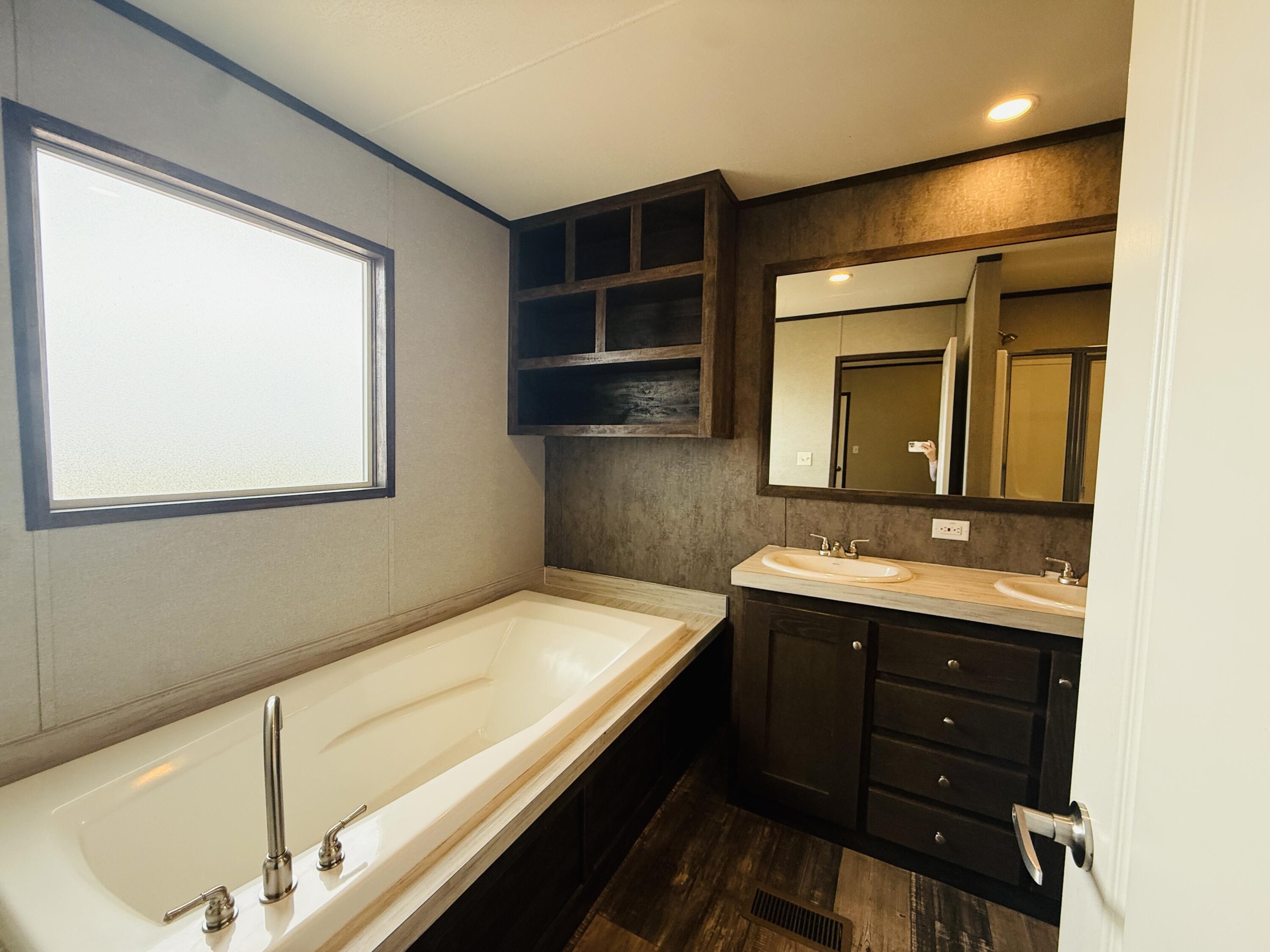 365 Private Road 211 Road North Seminole, TX 79360 - Photo 14 of 22 a bathroom with a sink and a mirror