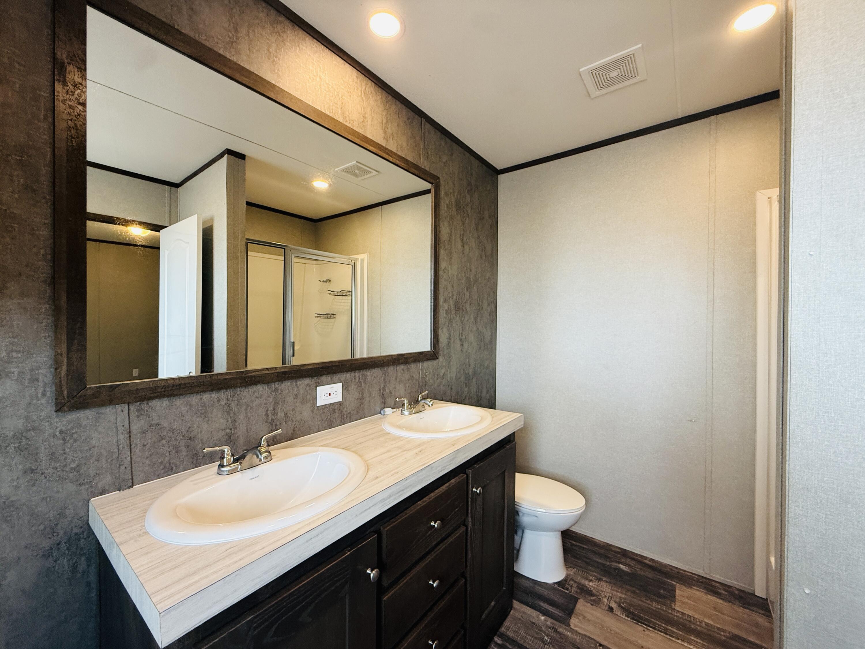 365 Private Road 211 Road North Seminole, TX 79360 - Photo 15 of 22 a bathroom with a sink and a mirror