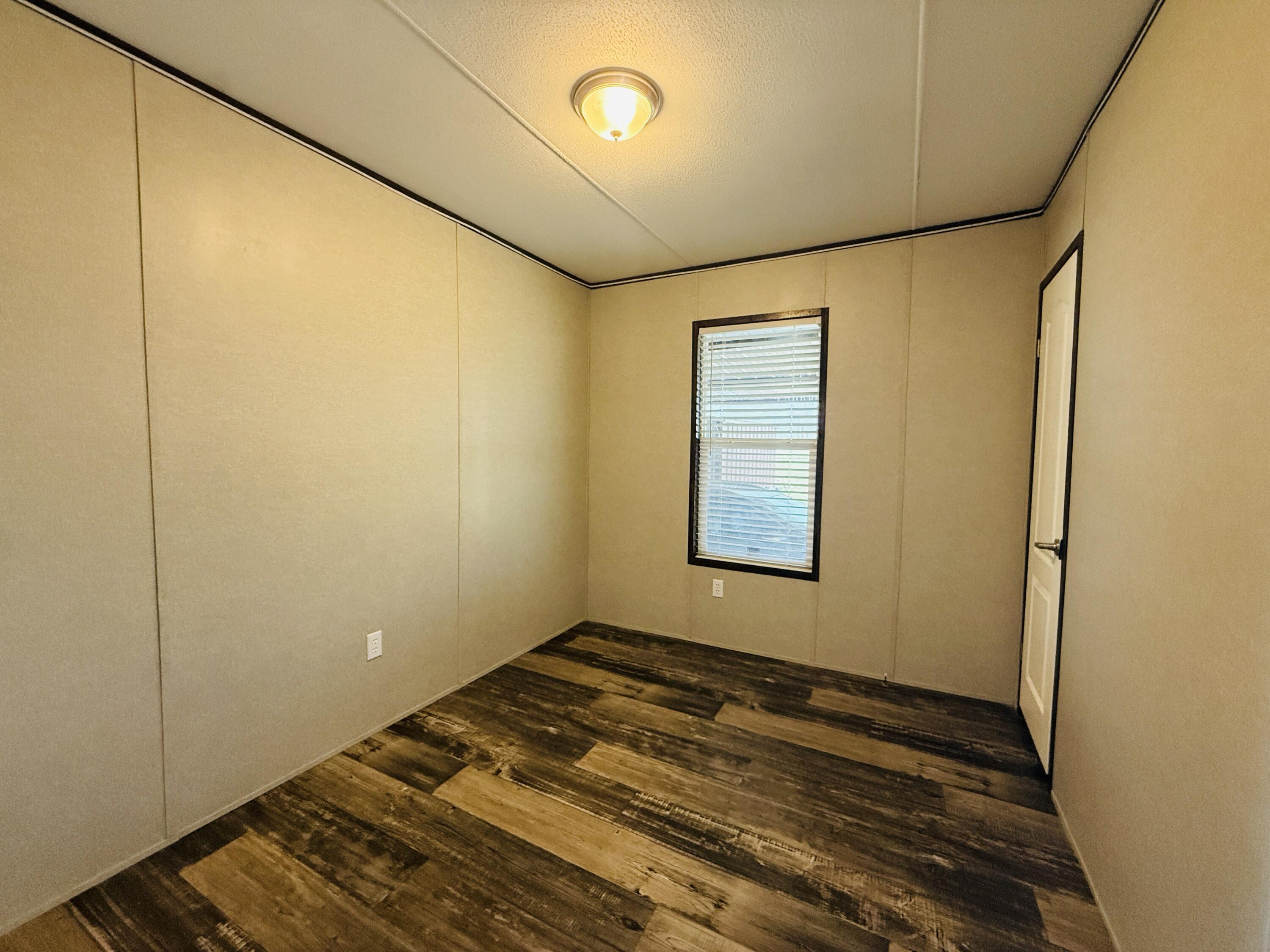 365 Private Road 211 Road North Seminole, TX 79360 - Photo 20 of 22 a view of room with window and wooden floor