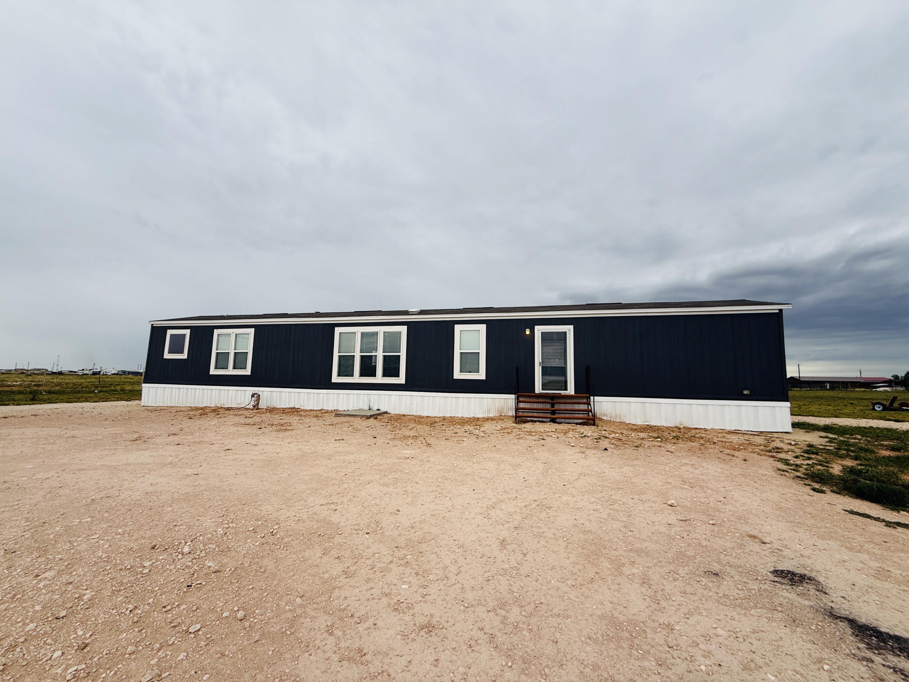 365 Private Road 211 Road North Seminole, TX 79360 - Photo 2 of 22 a house with trees in front of it
