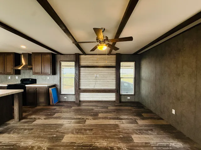 a kitchen with stainless steel appliances kitchen island granite countertop a refrigerator and a stove top oven