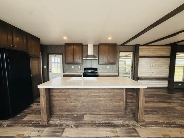 a kitchen with stainless steel appliances wooden cabinets and entryway
