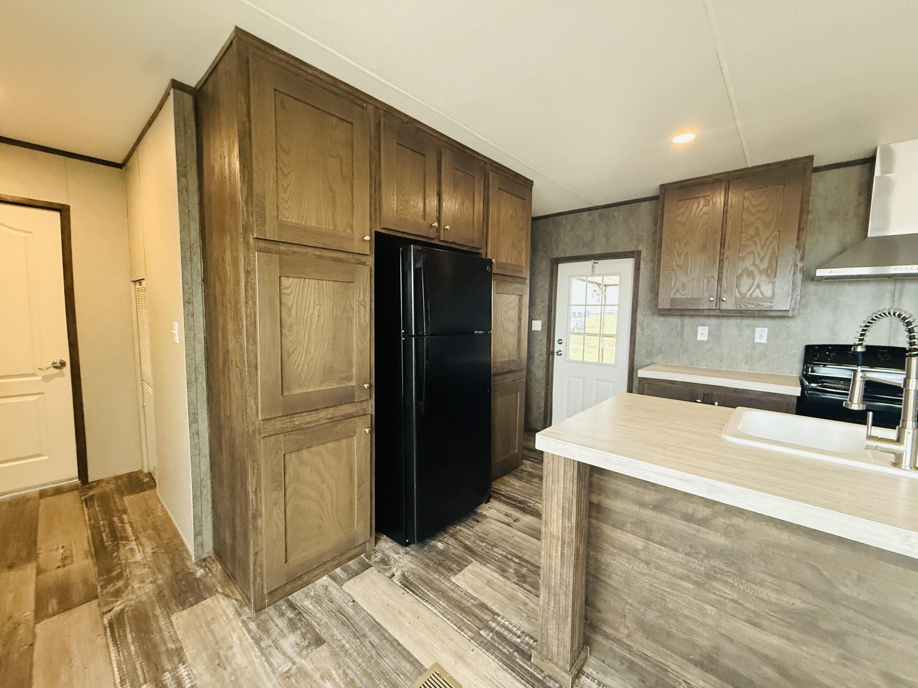 365 Private Road 211 Road North Seminole, TX 79360 - Photo 9 of 22 a kitchen with stainless steel appliances wooden cabinets and entryway