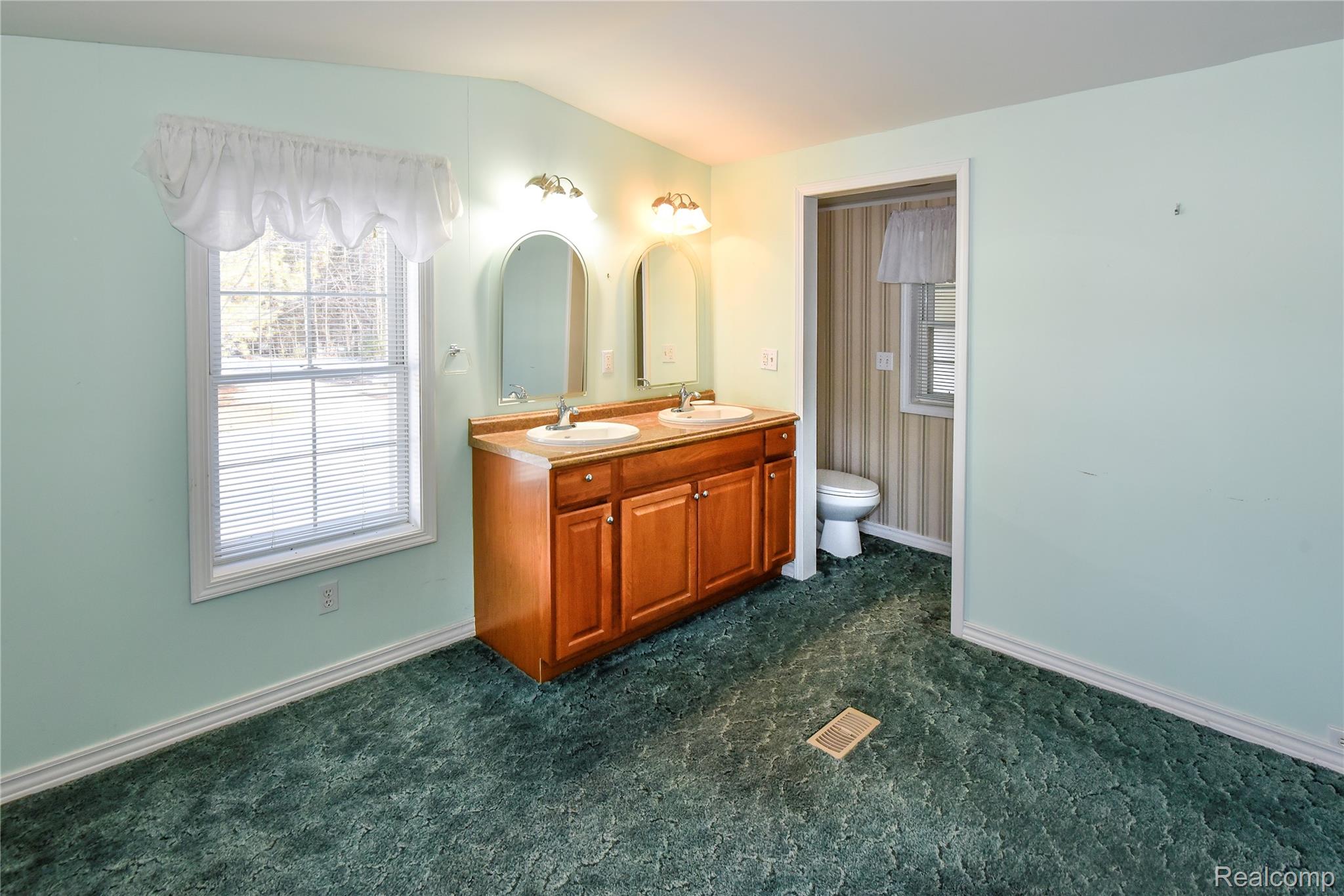 1094 Blamer Road Fairview, MI 48621 - Photo 47 of 97 Bathroom featuring double vanity and dark carpet