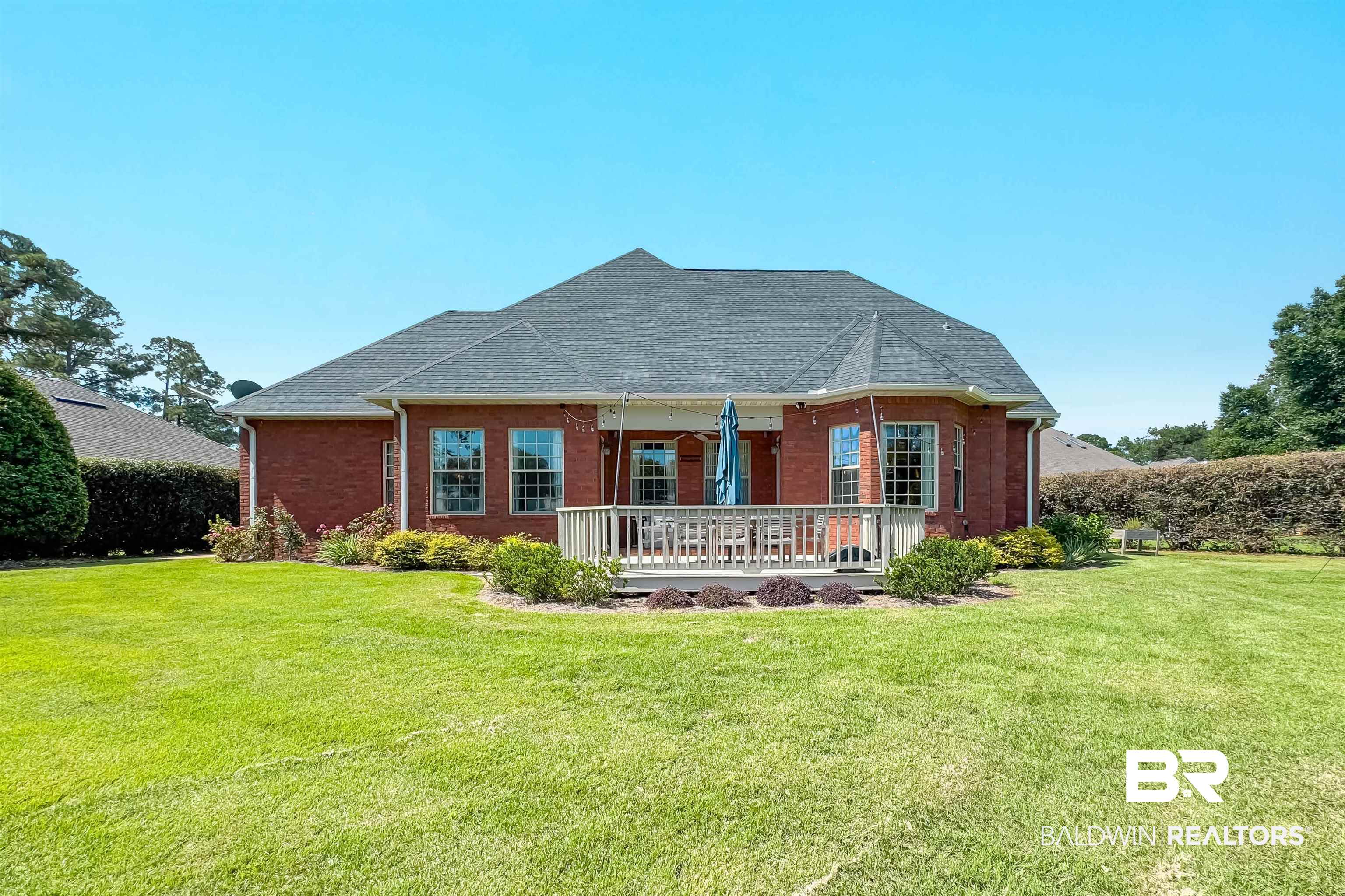 6630 East Quarry Drive Elberta, AL 36530 - Photo 54 of 63 Back of house with a yard, brick siding, roof with shingles, and covered porch