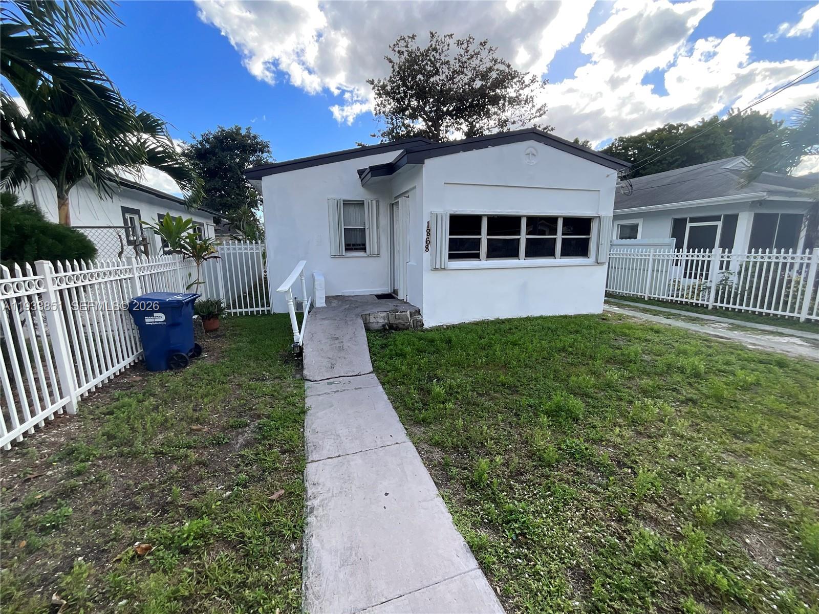 1868 Northwest 64th Street Miami, FL 33147 - Photo 1 of 21 a front view of a house with a yard