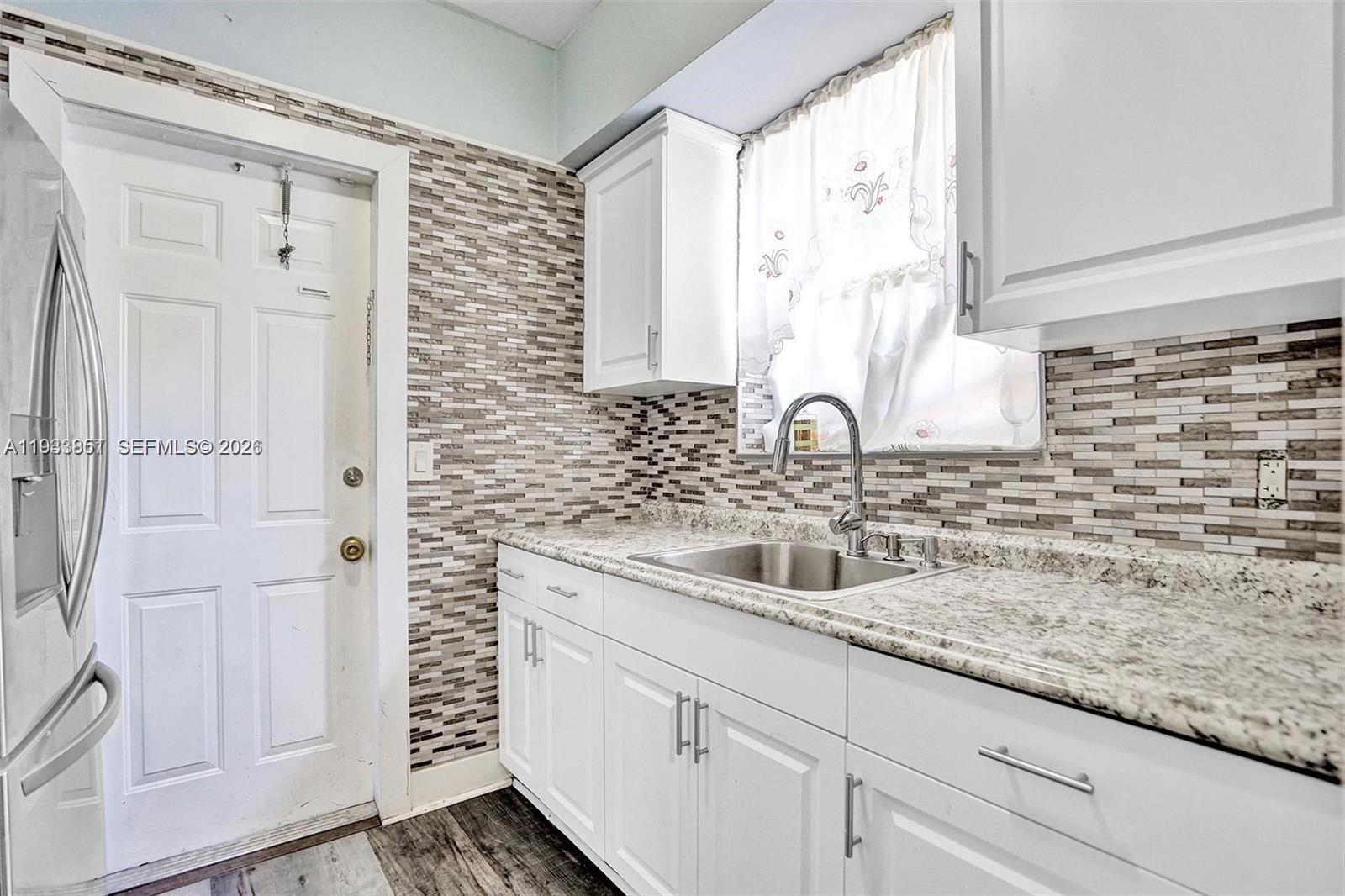 1868 Northwest 64th Street Miami, FL 33147 - Photo 12 of 21 a bathroom with a sink a vanity and a mirror