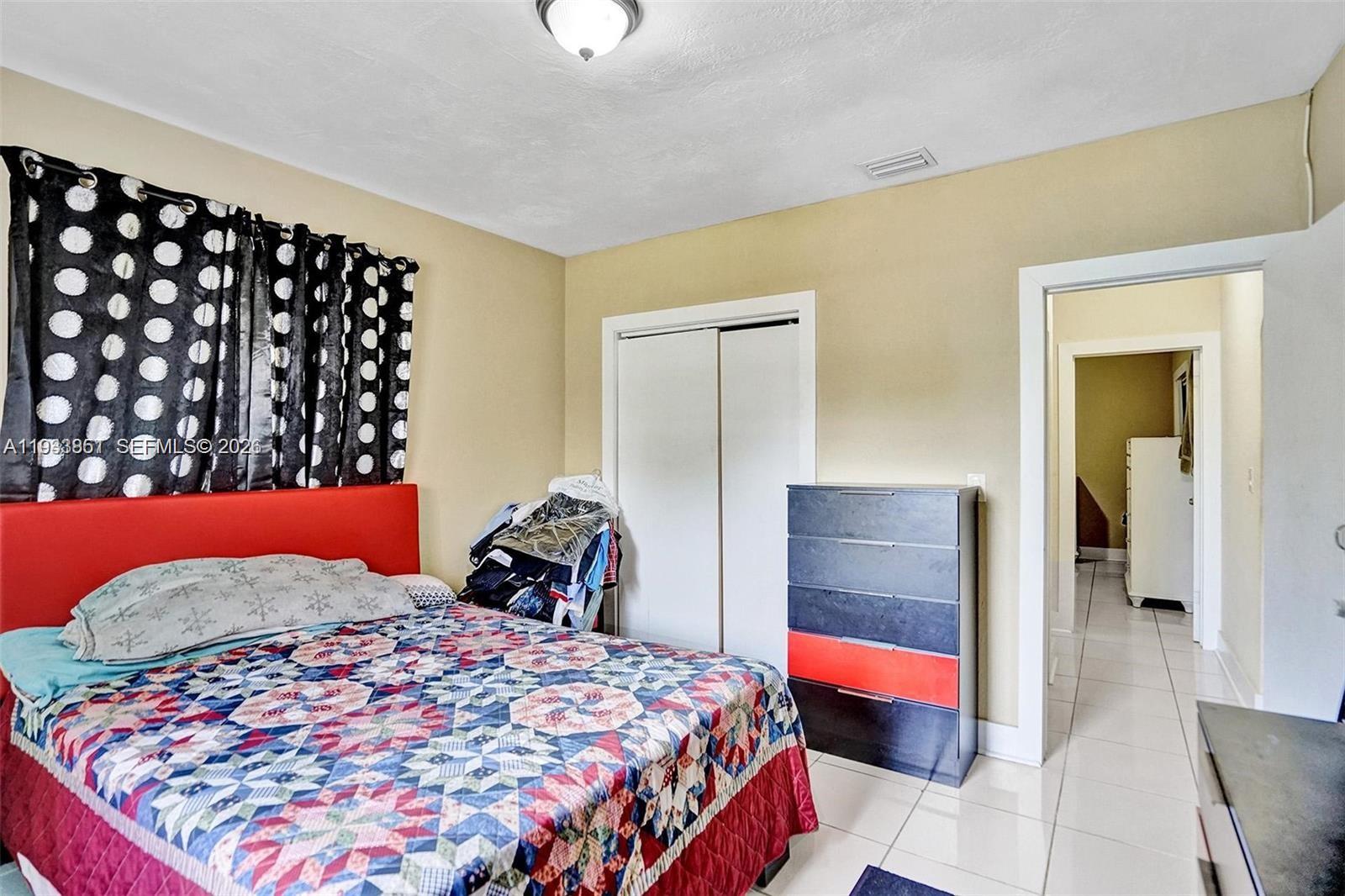 1868 Northwest 64th Street Miami, FL 33147 - Photo 14 of 21 a bedroom with a bed and a dresser