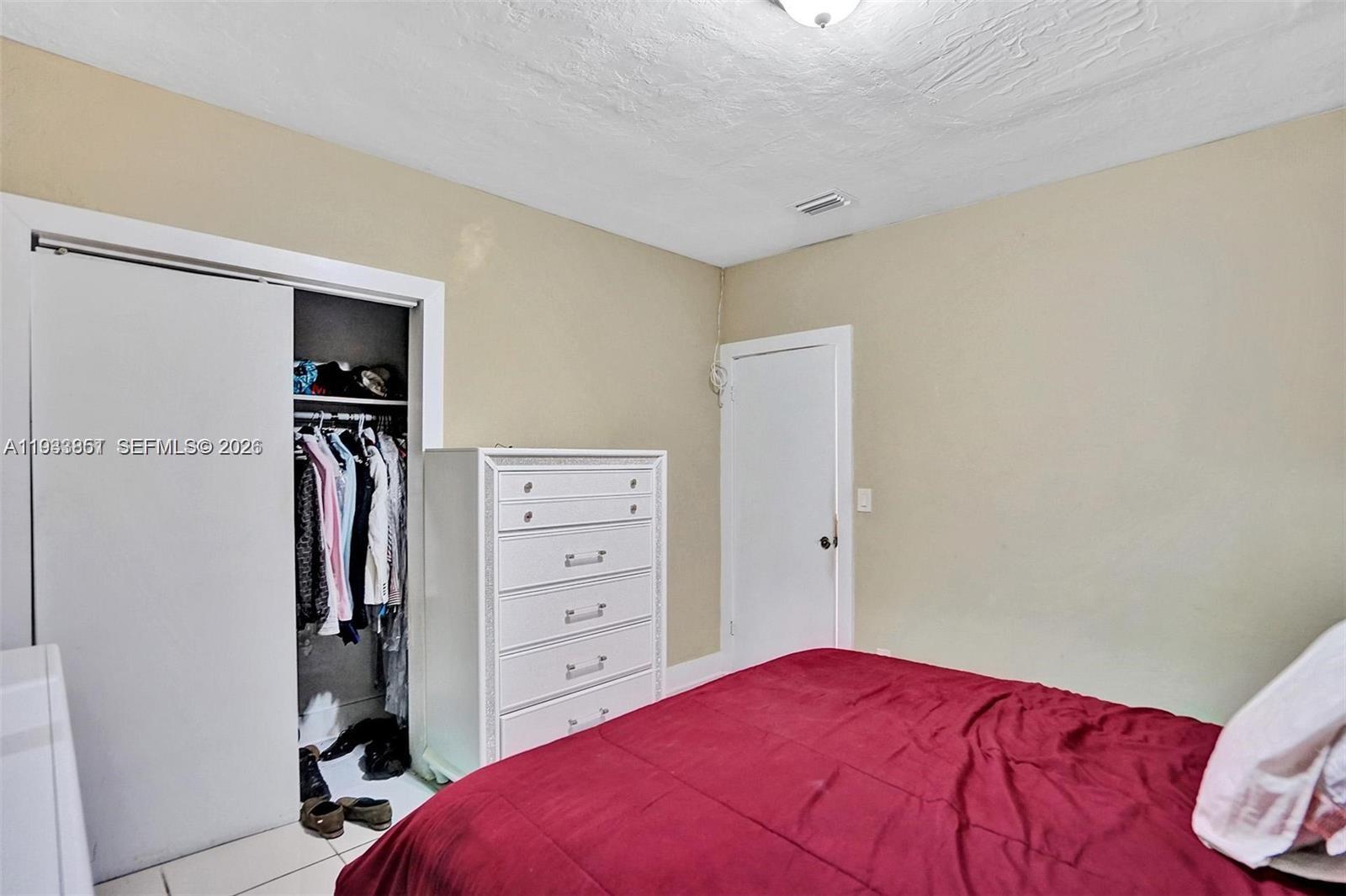 1868 Northwest 64th Street Miami, FL 33147 - Photo 16 of 21 a bedroom with a bed and a closet