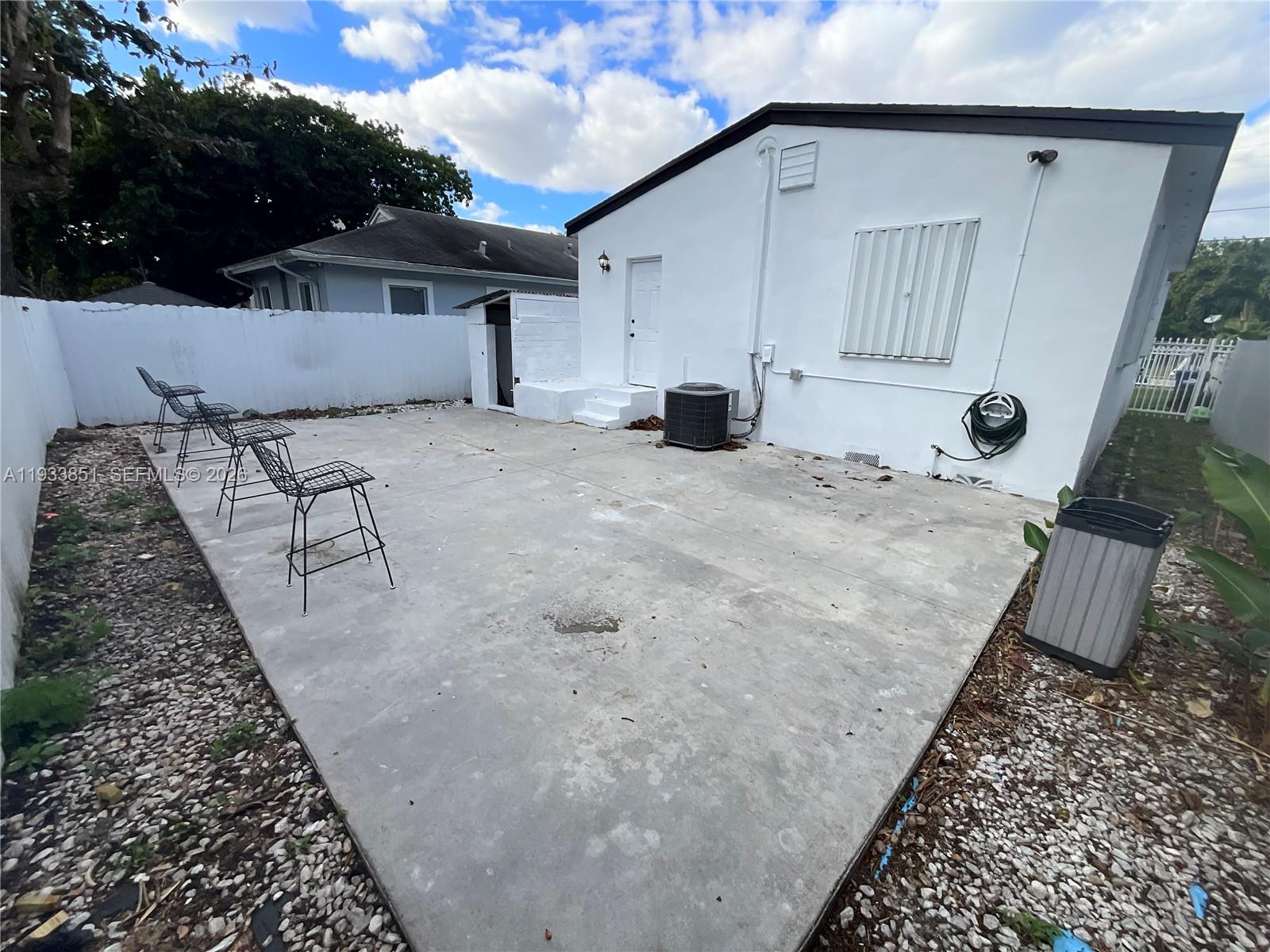 1868 Northwest 64th Street Miami, FL 33147 - Photo 19 of 21 a view of a house with backyard and sitting area