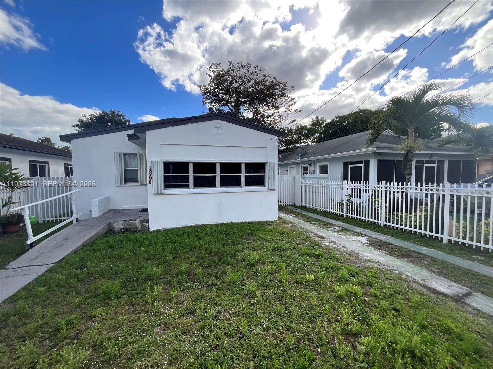 1868 Northwest 64th Street Miami, FL 33147 - Photo 2 of 21 a view of a house with a yard