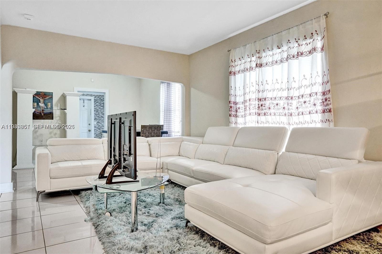 1868 Northwest 64th Street Miami, FL 33147 - Photo 6 of 21 a living room with furniture and a large window