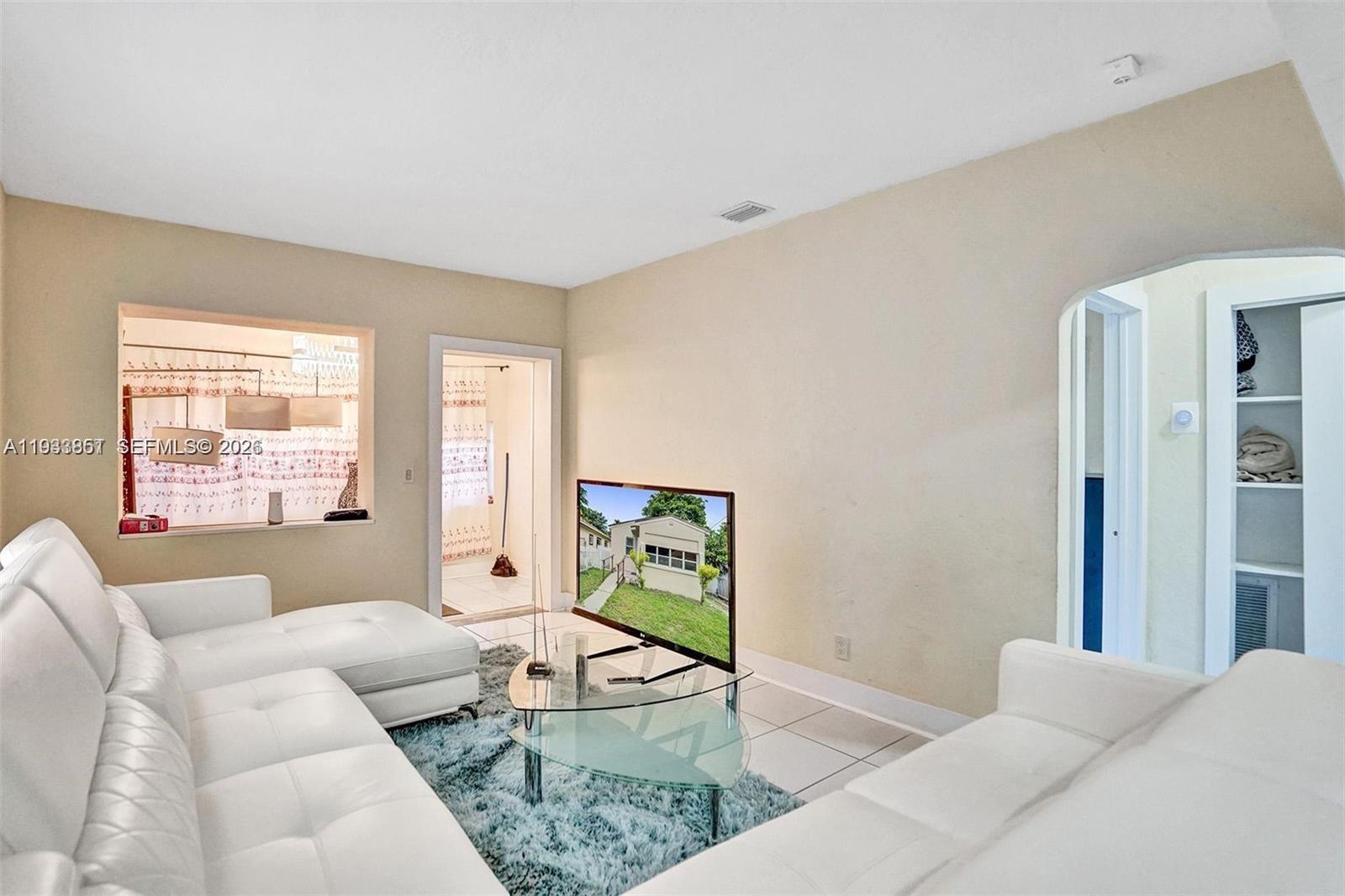 1868 Northwest 64th Street Miami, FL 33147 - Photo 7 of 21 a living room with furniture and a window