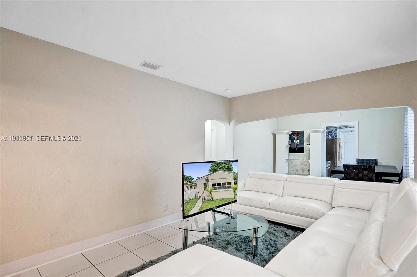 1868 Northwest 64th Street Miami, FL 33147 - Photo 8 of 21 a living room with furniture and wooden floor