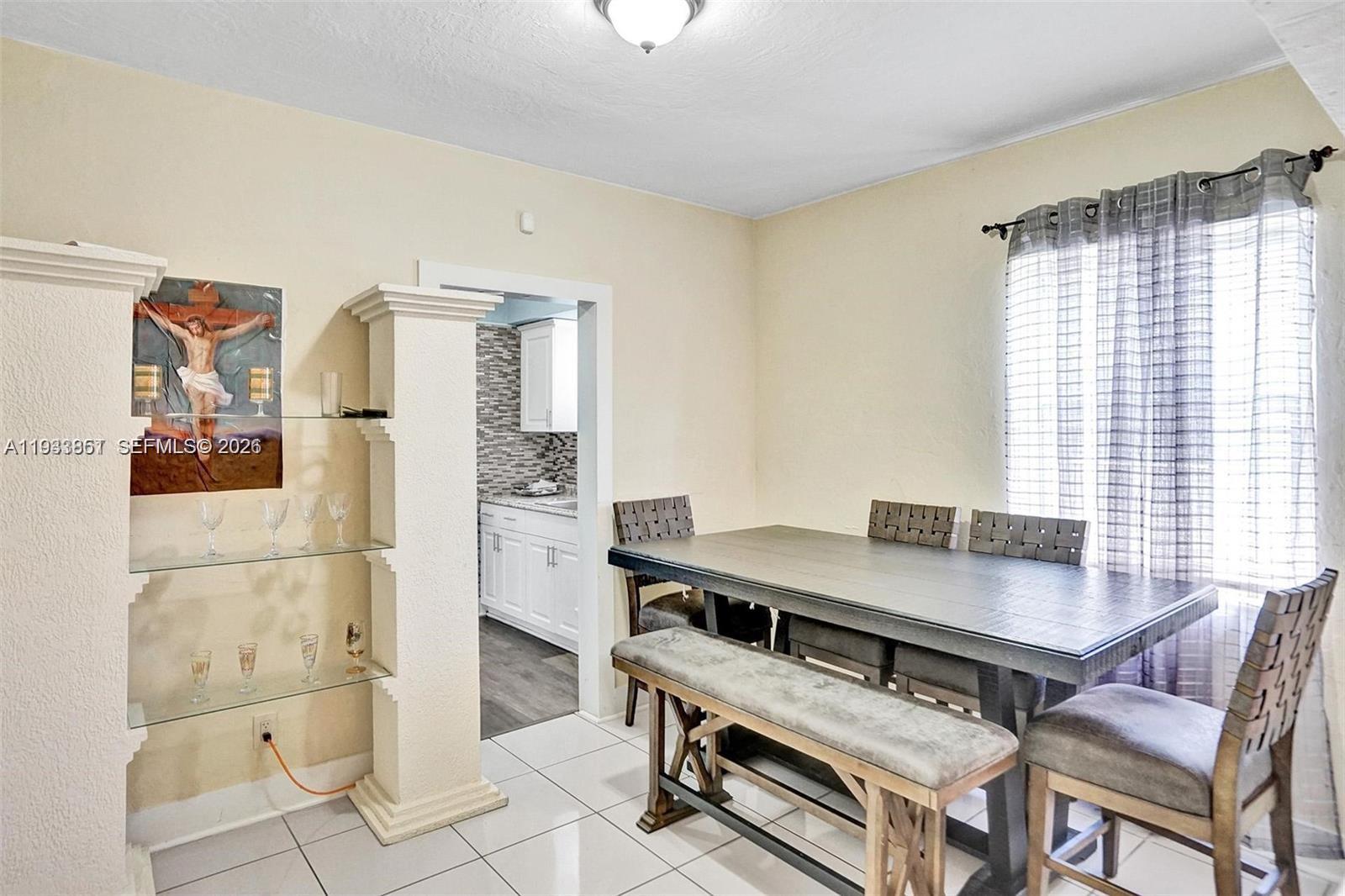 1868 Northwest 64th Street Miami, FL 33147 - Photo 9 of 21 a view of a dining room with furniture and window