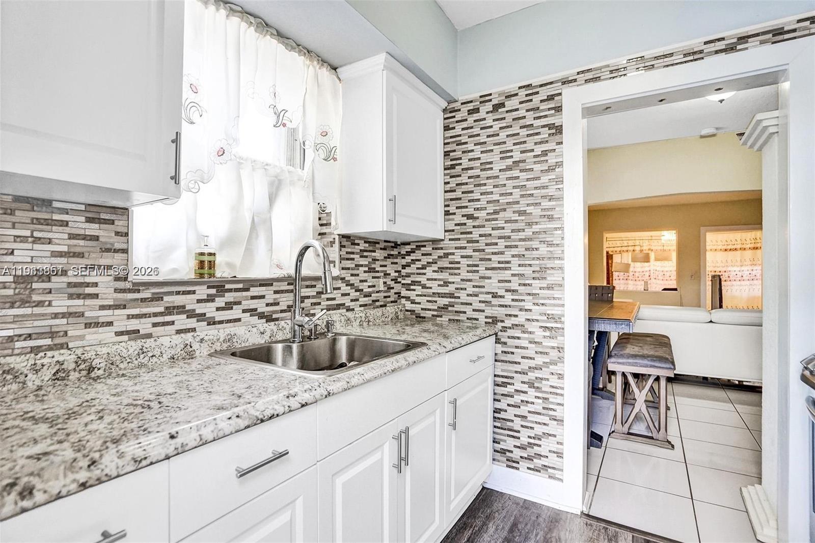1868 Northwest 64th Street Miami, FL 33147 - Photo 10 of 21 a kitchen with a sink and a window