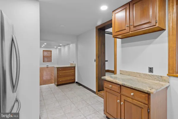 a kitchen with stainless steel appliances granite countertop a refrigerator a stove and a sink