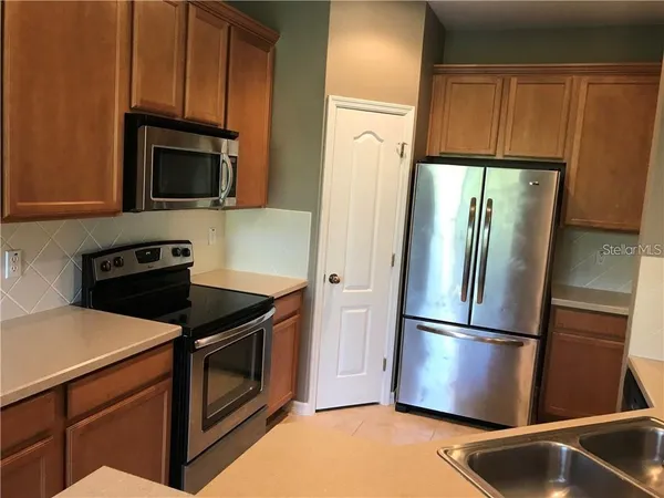 a kitchen with a refrigerator sink and microwave