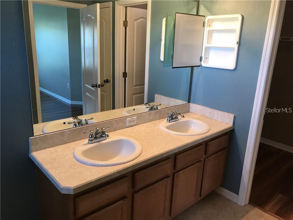 7542 Red Mill Circle New Port Richey, FL 34653 - Photo 18 of 27 a bathroom with a sink and a mirror