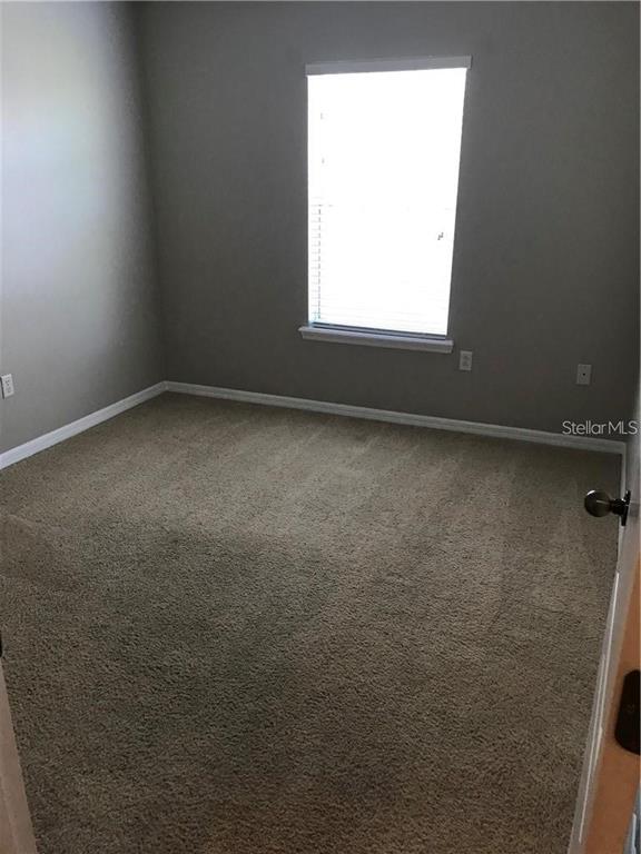 7542 Red Mill Circle New Port Richey, FL 34653 - Photo 21 of 27 an empty room with a window