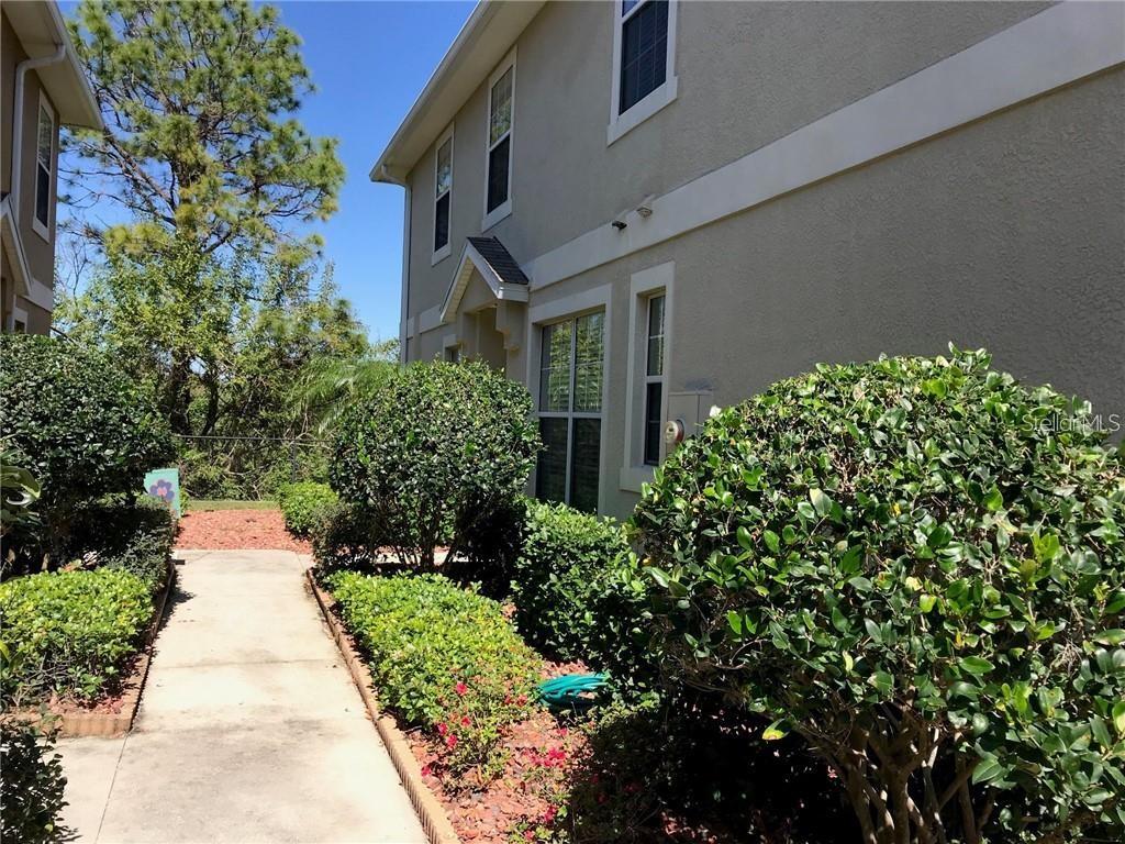 7542 Red Mill Circle New Port Richey, FL 34653 - Photo 26 of 27 a view of a pathway with house on both side
