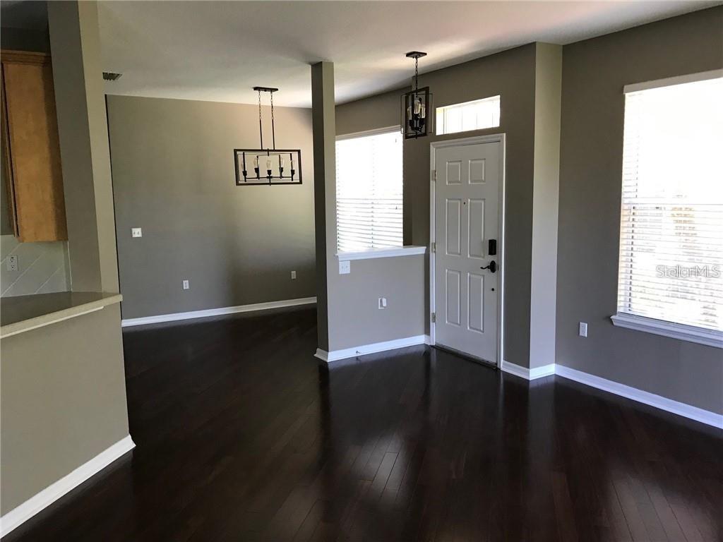7542 Red Mill Circle New Port Richey, FL 34653 - Photo 4 of 27 a view of a hallway with wooden floor
