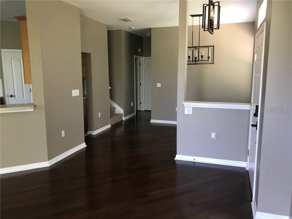 7542 Red Mill Circle New Port Richey, FL 34653 - Photo 5 of 27 an empty room with wooden floor and windows