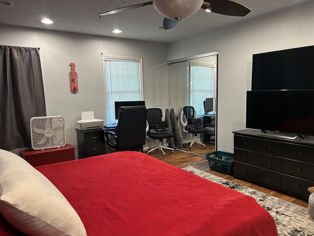 2125 13th Street, Unit 12 Columbus, GA 31906 - Photo 16 of 17 a bedroom with a bed and a flat screen tv