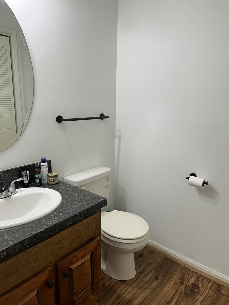 2125 13th Street, Unit 12 Columbus, GA 31906 - Photo 5 of 17 a bathroom with a granite countertop sink toilet and a mirror