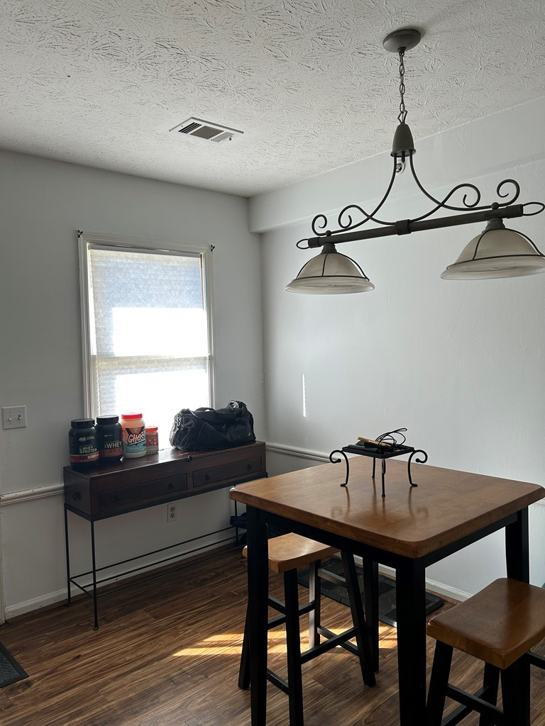 2125 13th Street, Unit 12 Columbus, GA 31906 - Photo 7 of 17 a living room with a table and chairs