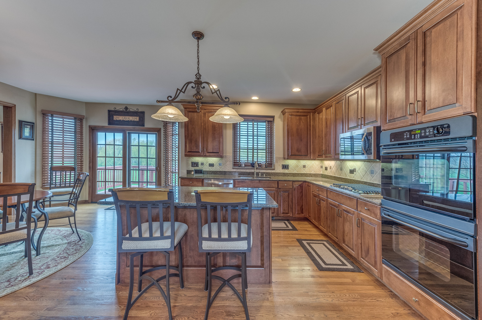 40W900 Campton Trail Road St. Charles, IL 60175 - Photo 12 of 31 a kitchen with stainless steel appliances granite countertop wooden floors stove and center island