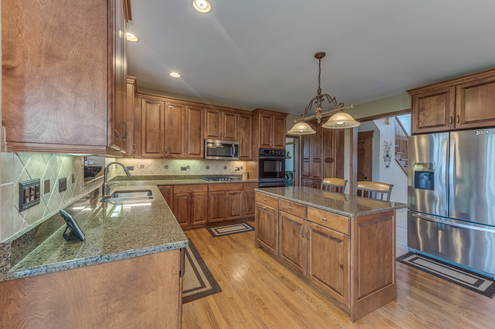 40W900 Campton Trail Road St. Charles, IL 60175 - Photo 13 of 31 a kitchen with stainless steel appliances granite countertop a sink a stove and a refrigerator