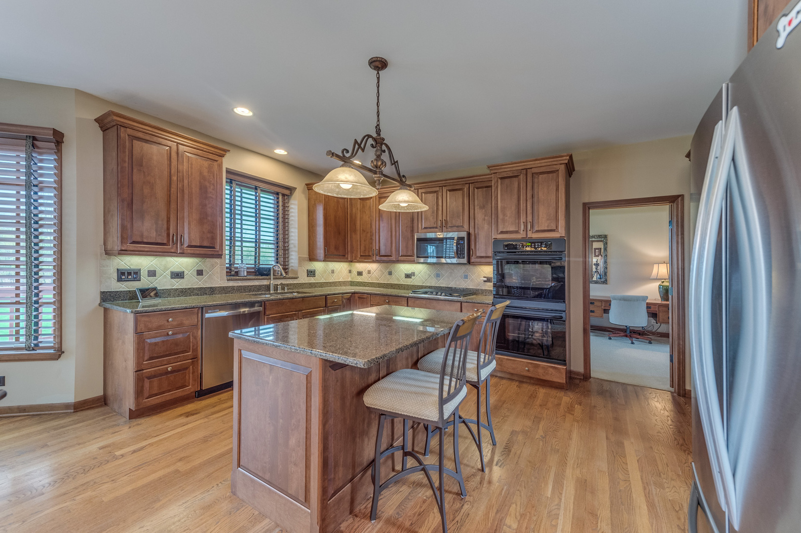 40W900 Campton Trail Road St. Charles, IL 60175 - Photo 14 of 31 a kitchen with kitchen island a large counter top space appliances and cabinets