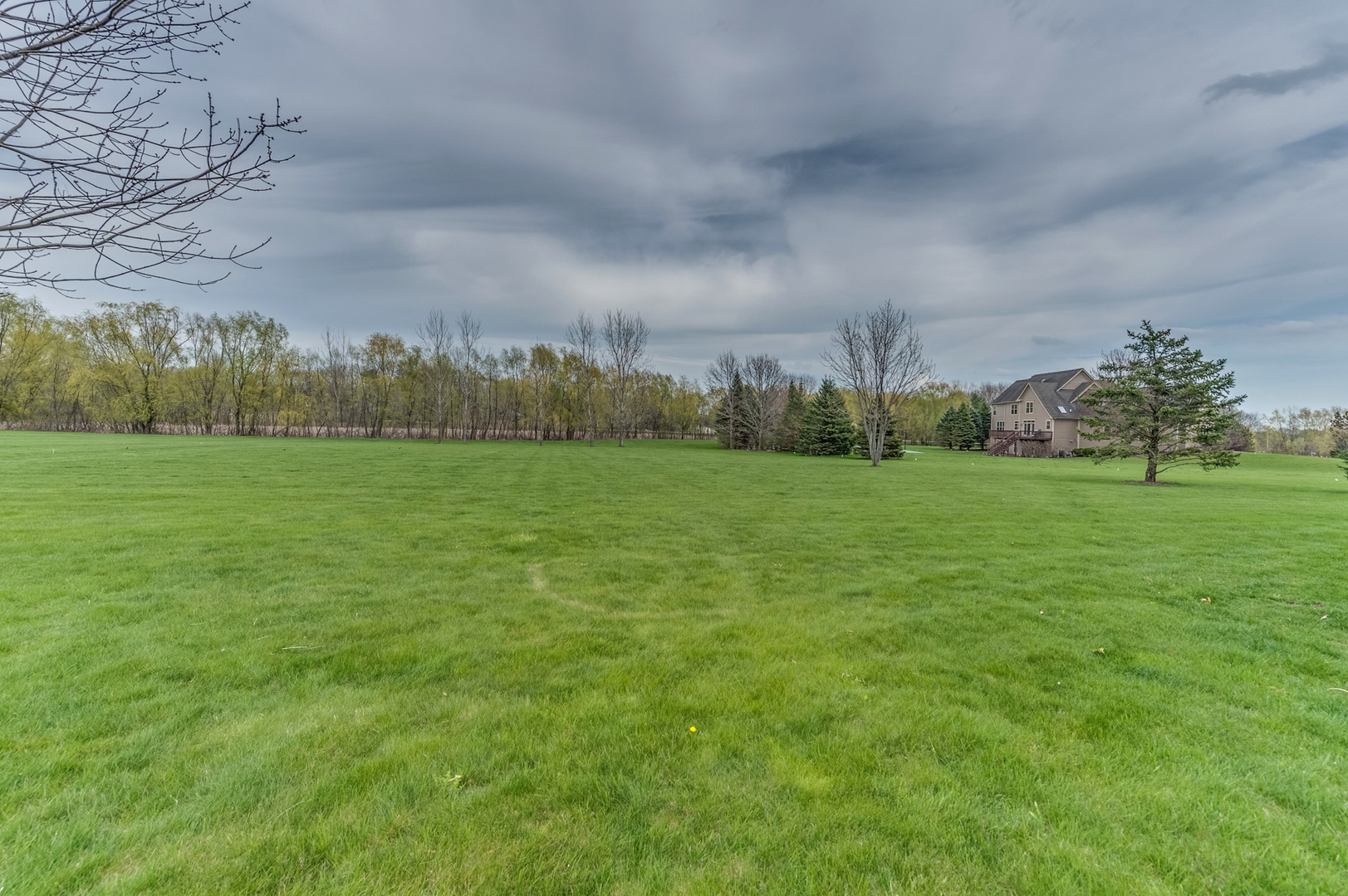 40W900 Campton Trail Road St. Charles, IL 60175 - Photo 29 of 31 a view of a green field with trees in the background