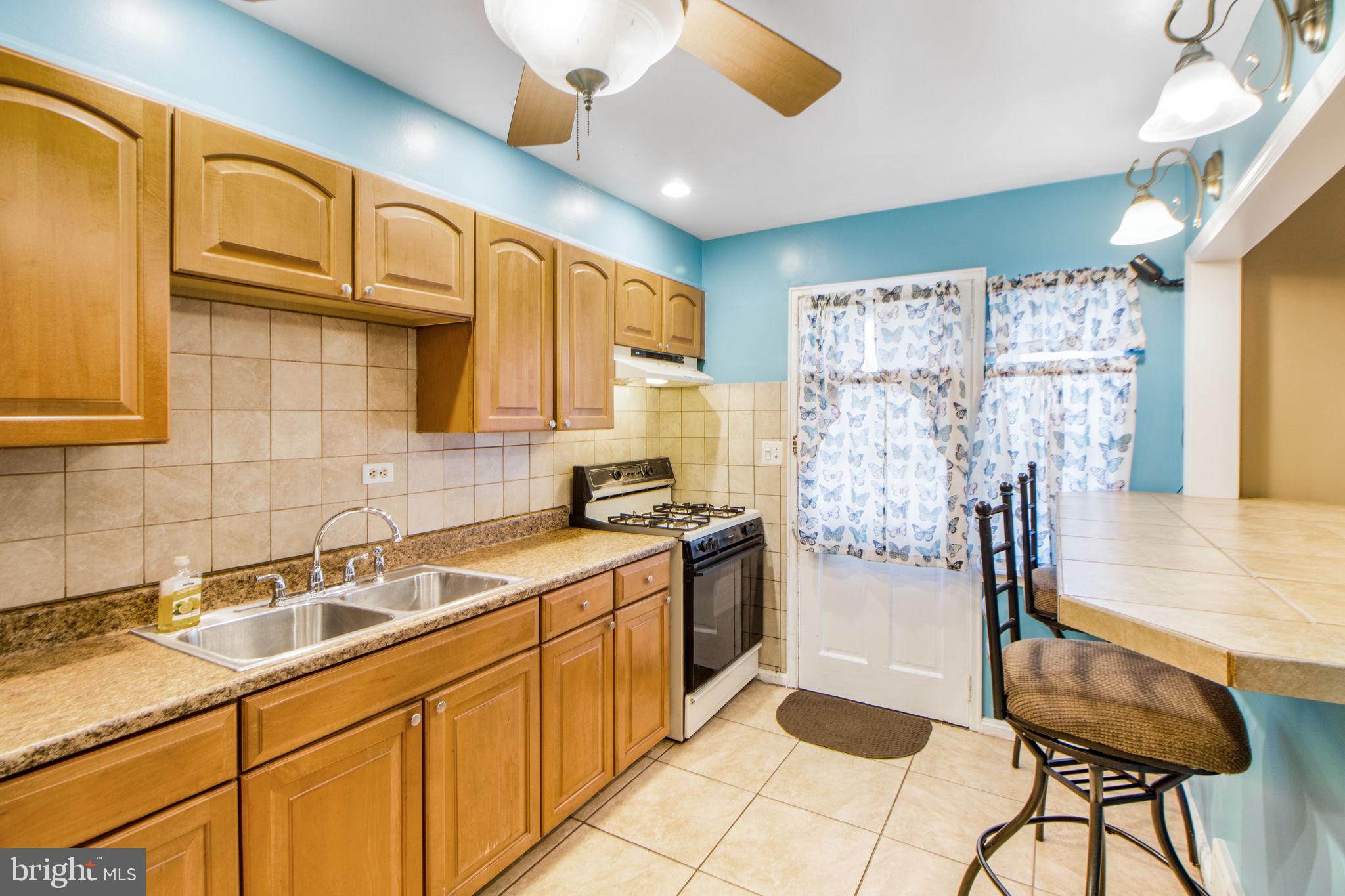 1903 Heathfield Road Baltimore, MD 21239 - Photo 10 of 30 a kitchen with stainless steel appliances granite countertop a sink and cabinets