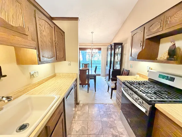 a kitchen with a sink a stove and chairs