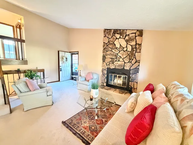 a living room with furniture a couch and a fireplace