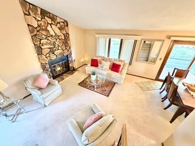 a living room with furniture and a floor to ceiling window