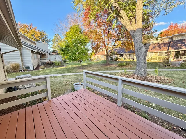 a view of backyard with wooden floor and fence