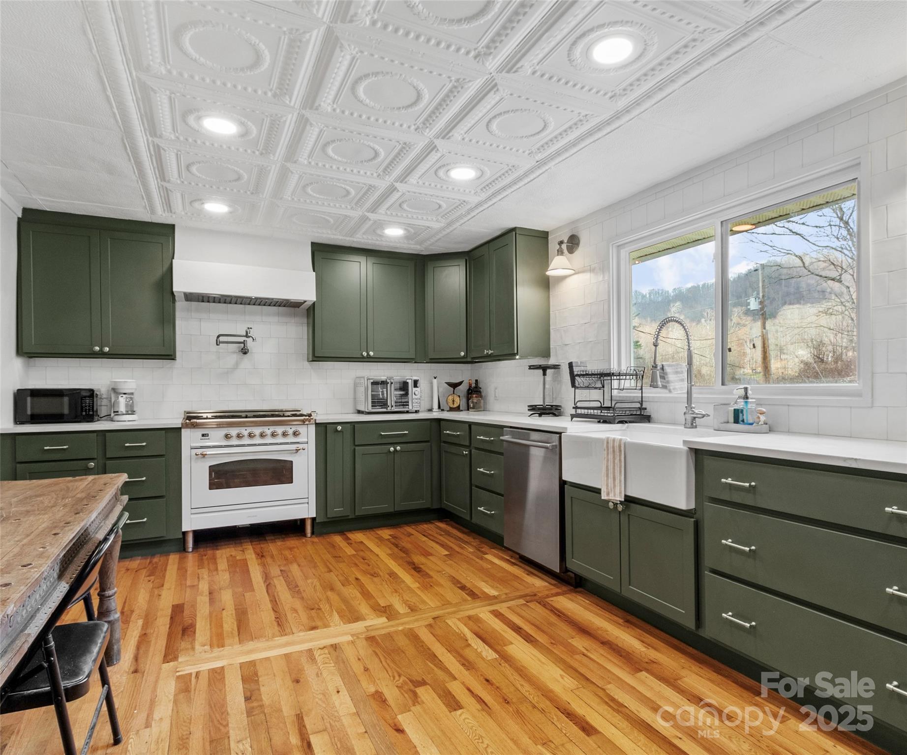 456 Windy Gap Road Mars Hill, NC 28754 - Photo 16 of 47 a large kitchen with stainless steel appliances wooden cabinets and a stove